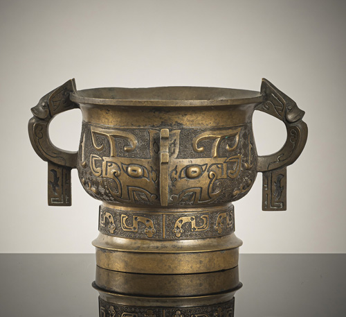 <b>A golden-brown bronze of a 'Gui' with large Taotie masks</b>