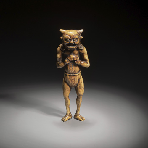 <b>A well carved coloured ivory  netsuke of a tall oni</b>