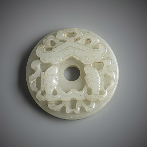 <b>A fine pendant made of light green jade in bi-form with double fish motif in relief</b>