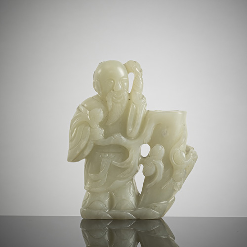 <b>A jade group with immortals next to a trunk worked as a vase</b>