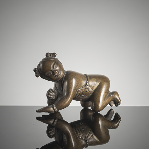 <b>A bronze paper weight in the shape of a boy</b>