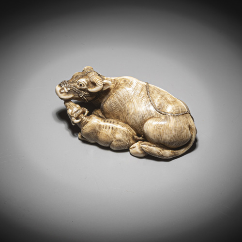 <b>Netsuke of a reclining cow with an ivory calf</b>