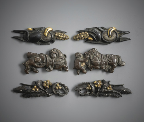 <b>Three pairs of menuki made of shakudô or copper with gold details</b>