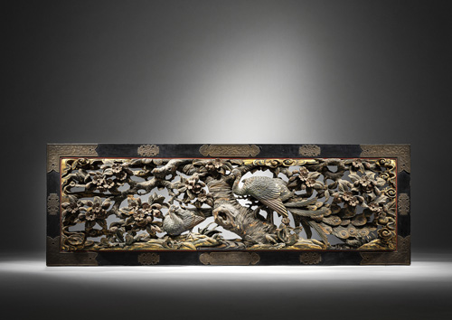 <b>A decorative carved wood paneel with a depiction of a pair of peacocks</b>