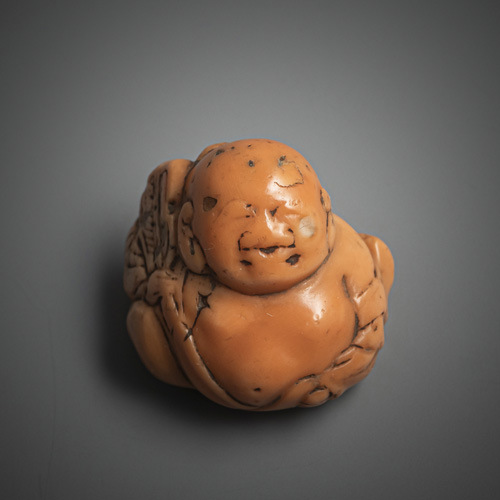 <b>A small coral netsuke of Hotei</b>