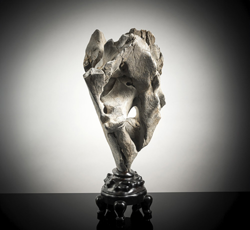 <b>A scholar's stone (gongshi) in the form of a high rock, partly in openword, on a wooden stand</b>