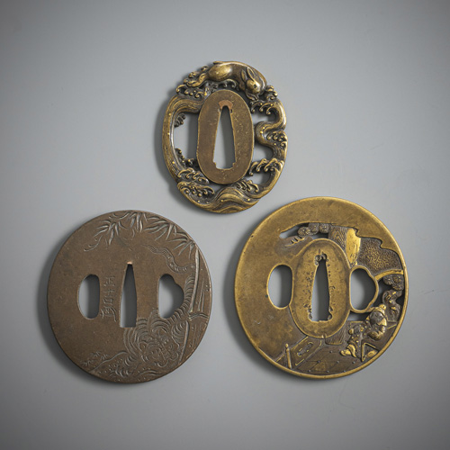 <b>Two brass tsuba and one copper tsuba</b>