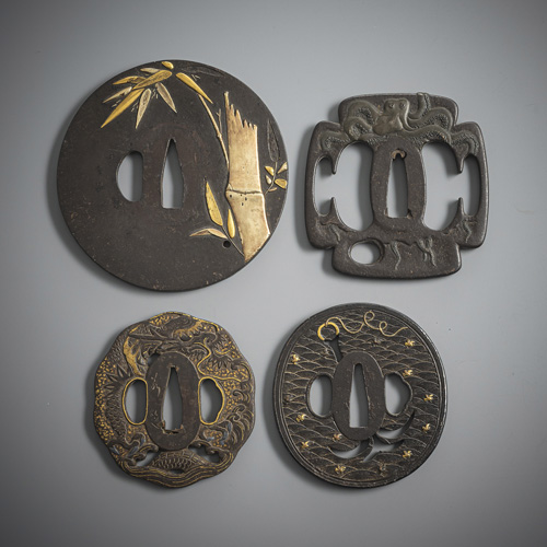 <b>Four iron tsuba, partly inlaid or gilded</b>