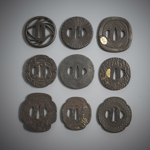 <b>Group of nine iron tsuba, partly inlaid</b>