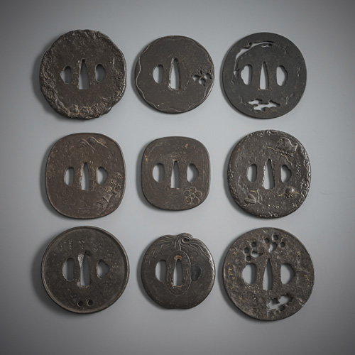 <b>A group of nine iron tsuba, some with details in gold</b>