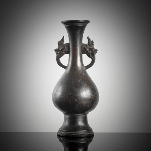 <b>A bronze baluster vase with two handles on a wooden stand</b>