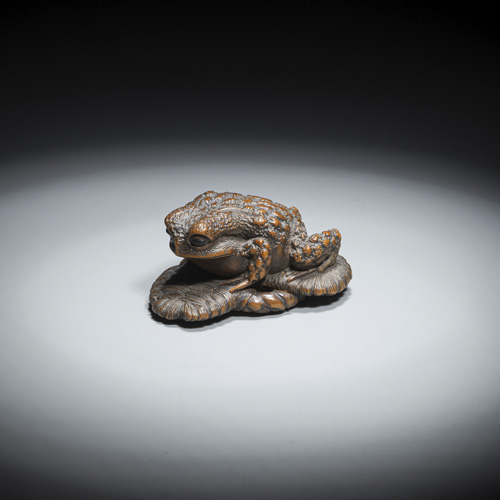 <b>A fine carved boxwood Netsuke of a toad on a  sandal</b>