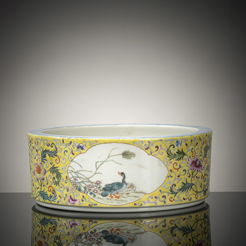 <b>A flat porcelain jardinière with 'Famille rose' decoration on a yellow ground</b> <b>A flat porcelain jardinière with 'Famille rose' decoration on a yellow ground</b>