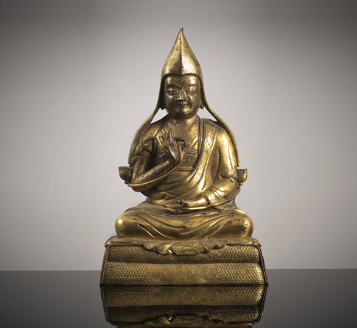 <b>A gilt-bronze figure of a seated lama</b>