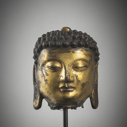 <b>A gilt-bronze head of Buddha</b>