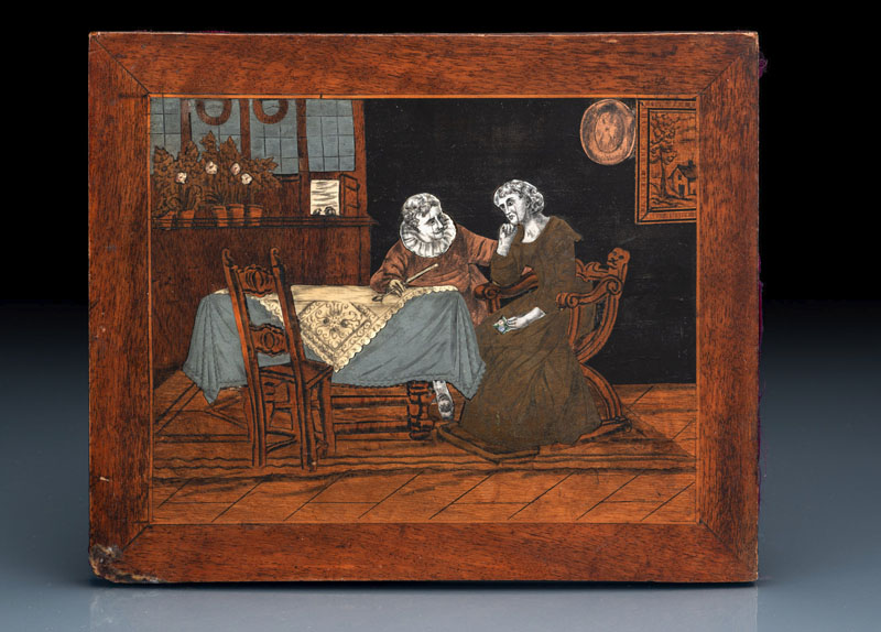 <b>A BRASS METAL AND IVORY INLAID WOOD PANEL WITH COUPLE IN AN INTERIOR</b>