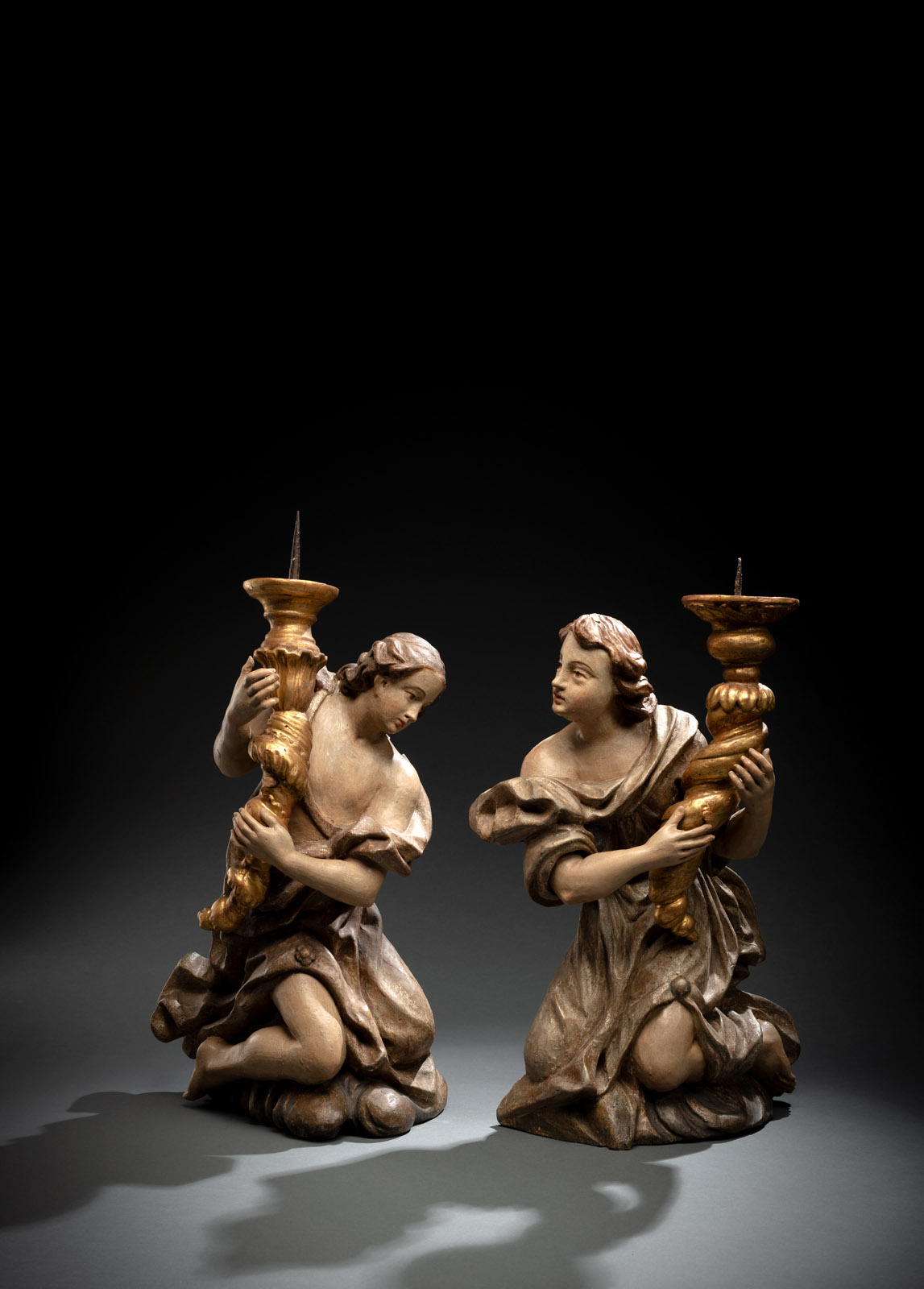 <b>A PAIR OF BAROQUE ANGELS WITH CANDLESTICKS</b>