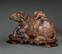 <b>A CARVED SOAPSTONE RECUMBENT BUFFALOE WITH HERD BOY AND CARVED WOOD STAND</b>