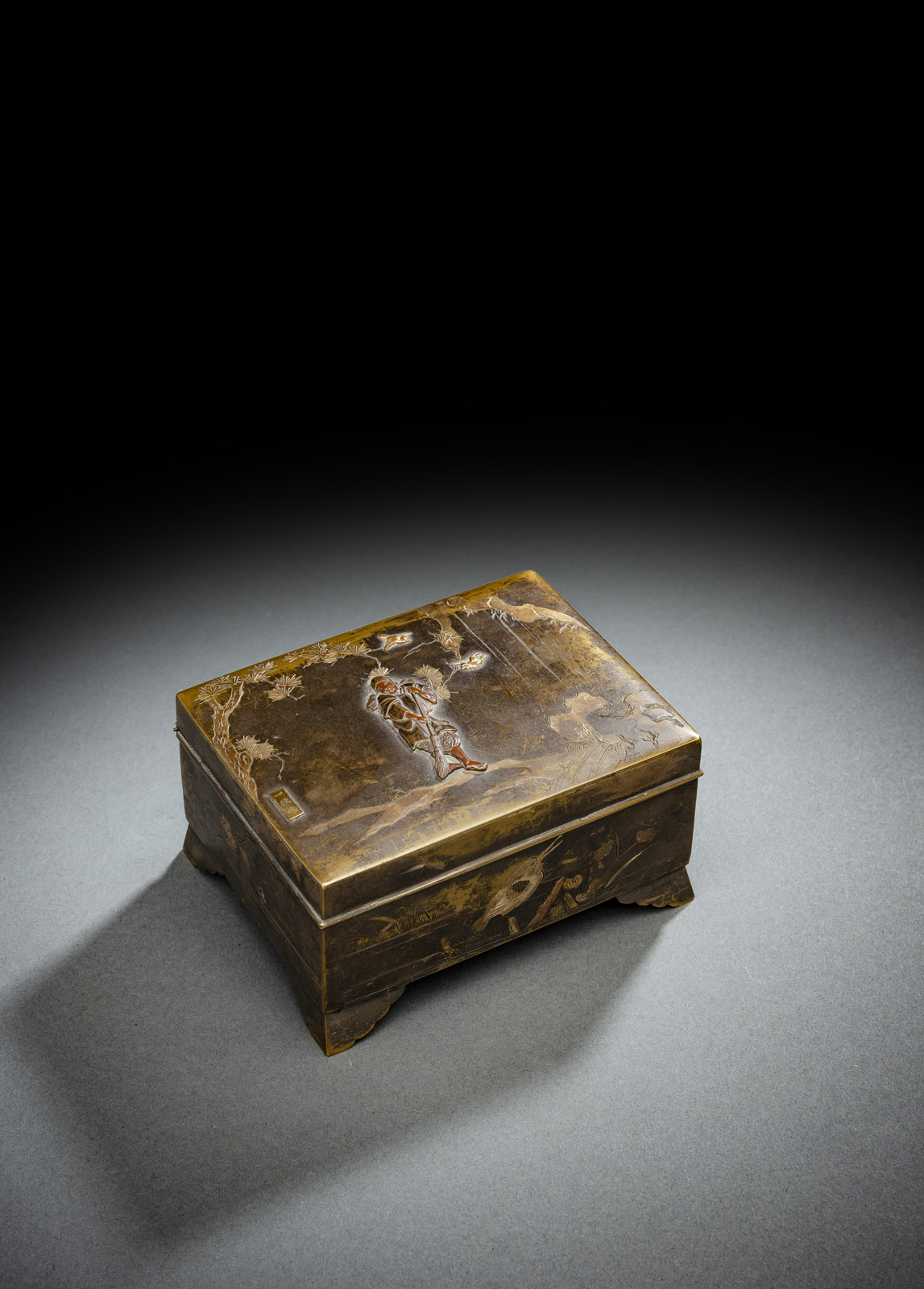 <b>A BRONZE BOX WITH HINGED COVER DECORATED WITH A SWEEPING MAN AND TWO BIRDS IN A PINE TREE</b>