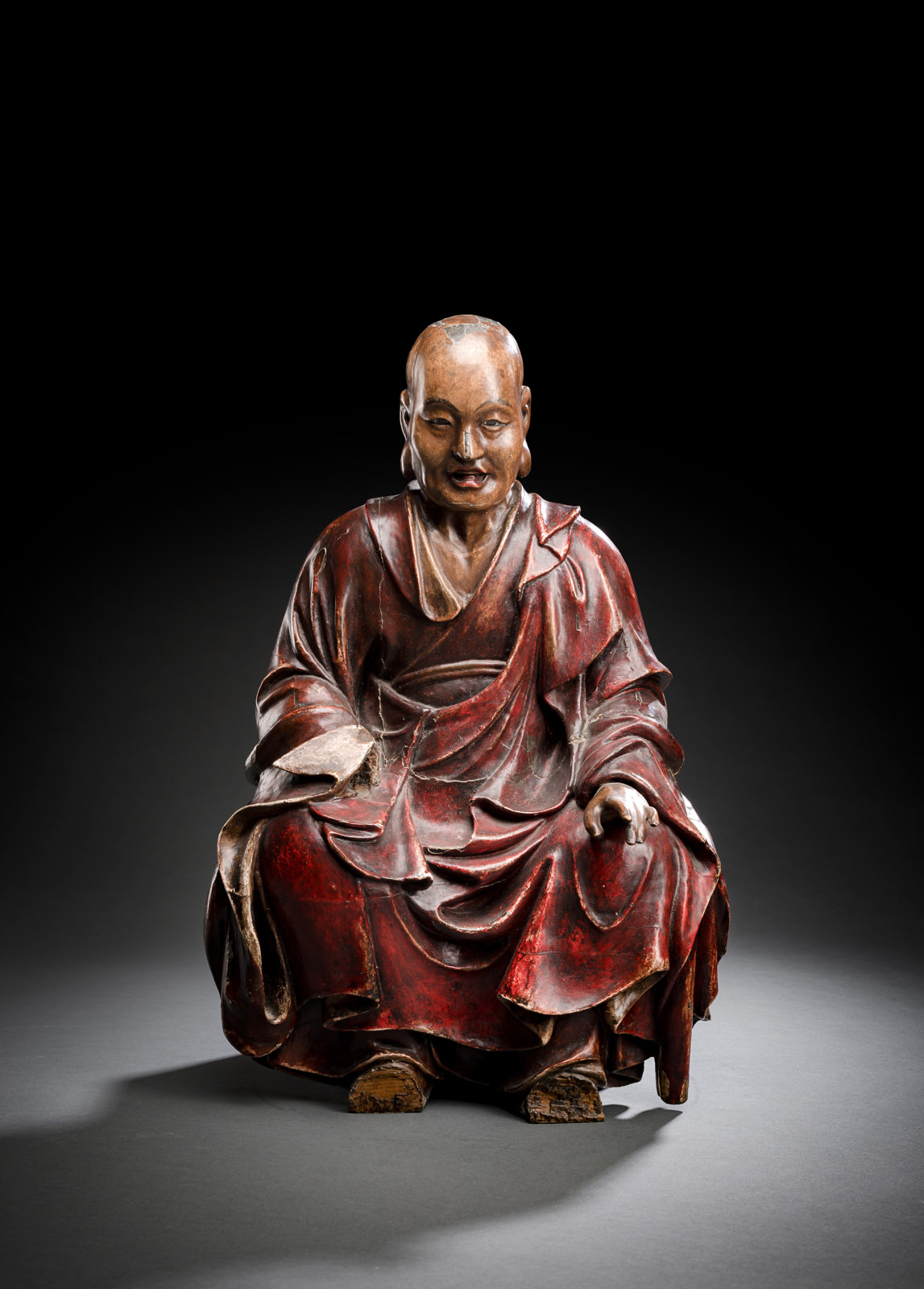 <b>A POLYCHORME-LACQUERED WOOD FIGUR OF A SEATED MONK</b>