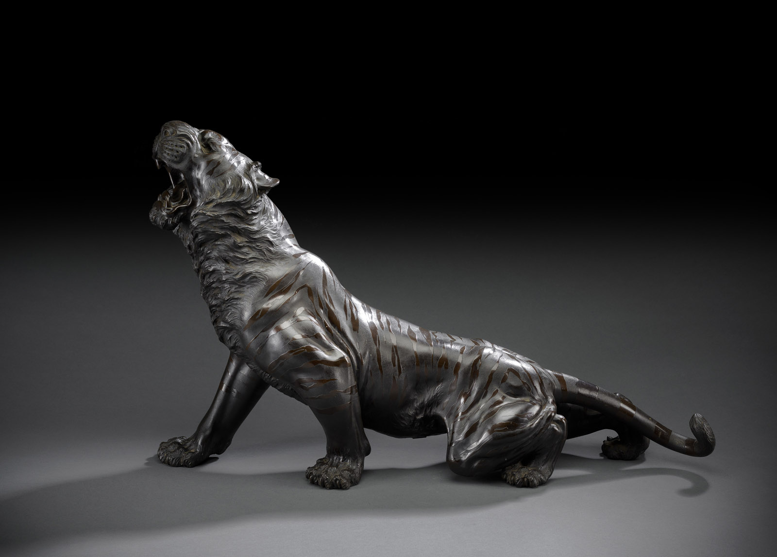 <b>A CAST BRONZE MODEL OF A CREEPING AND ROARING TIGER</b>