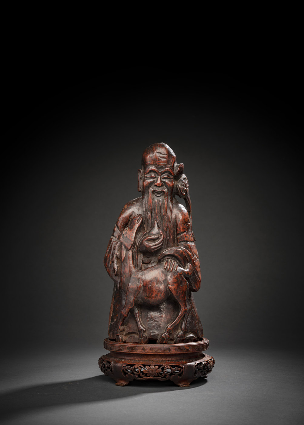 <b>A CARVED BAMBOO FIGUR E OF SHOULAO HOLDING A PEACH  ACCOMPANIED BY A  DEER AND A BAT</b>