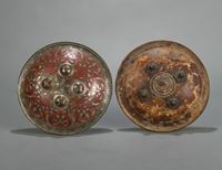 <b>TWO PARTIALLY SILVER-DAMASCENED HORN AND METAL SHIELDS</b>
