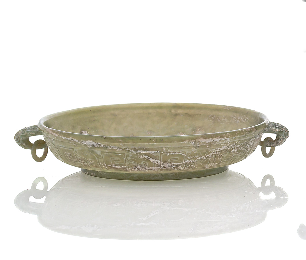 <b>A FINE CARVED LIGHT GREEN JADE BOWL WITH TWO HANDLES IN ARCHAIC STYLE</b>